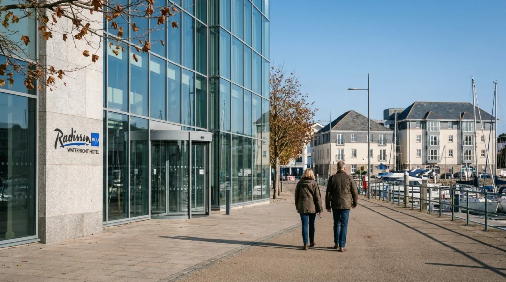 A wide-angle view of the exterior of the Radisson Blu Waterfront Hotel in Jersey, Channel Islands, on a clear autumn morning,