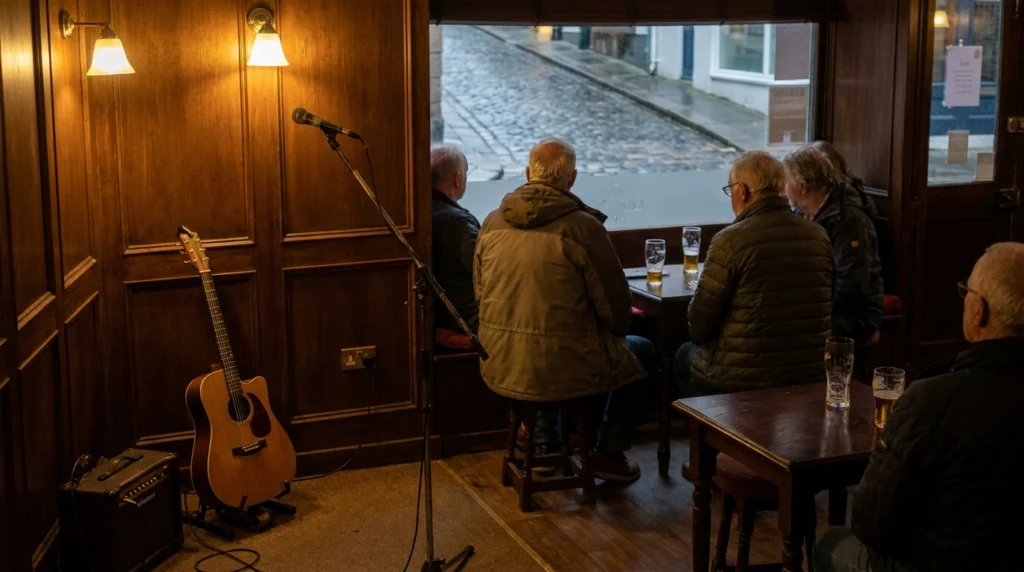 A warm, intimate interior of a small St Helier cafe-bar in the evening, with low lighting, wooden tables and a small cleared